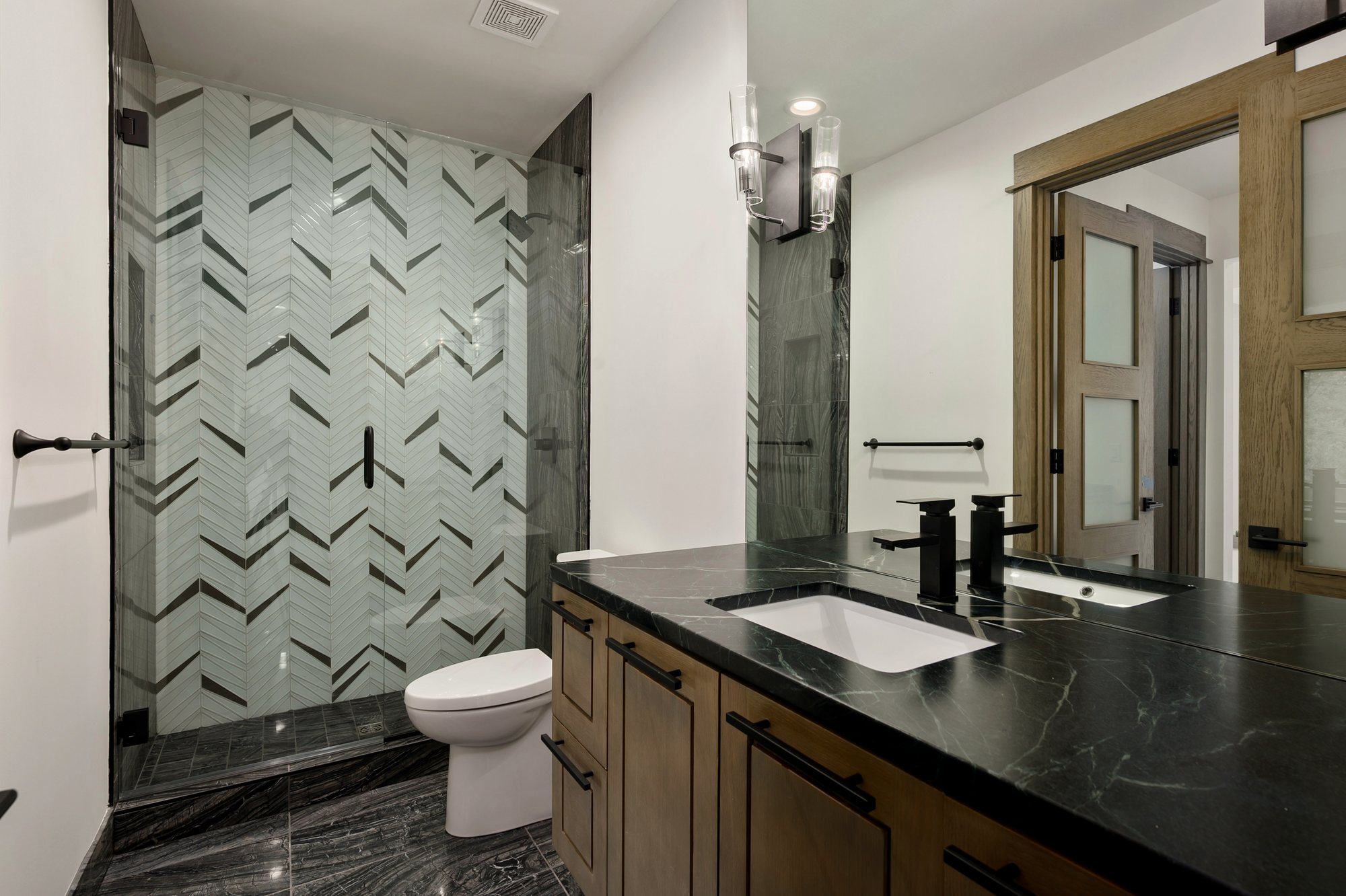 Custom residence — stone vanity with tiled shower