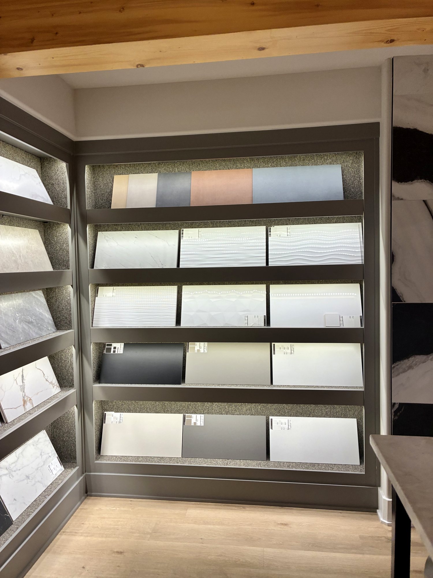 Showroom tile sample wall with luxury vinyl plank flooring