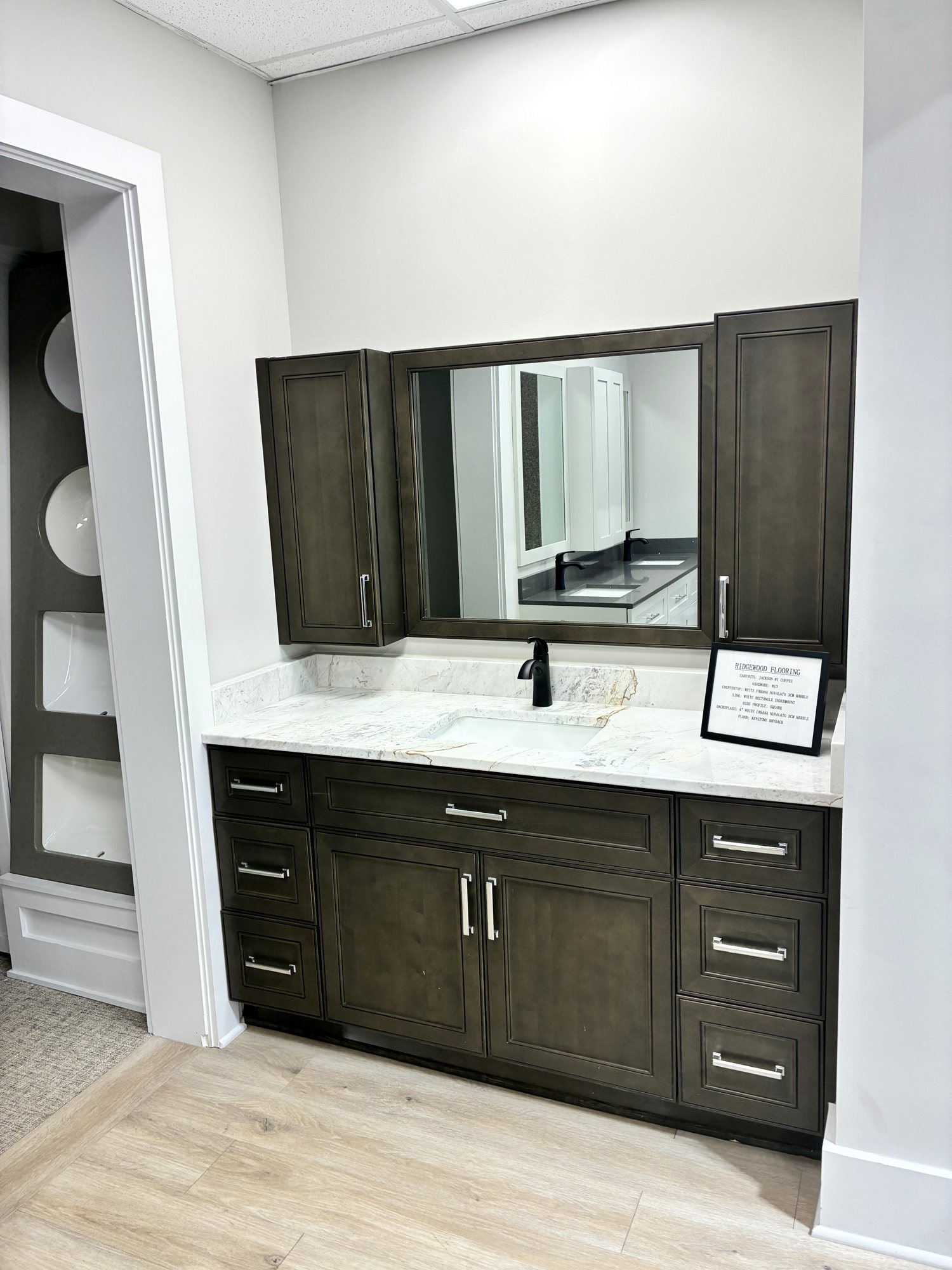 Dark vanity cabinetry with mirror